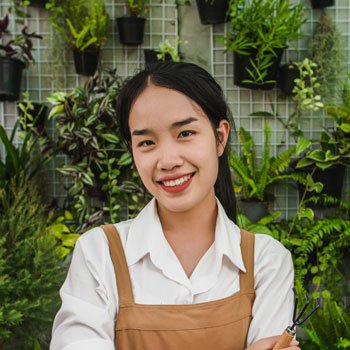 portrait-young-asian-gardener-female-wearing-apron-stand-cross-arm-she-smile-looking-camera